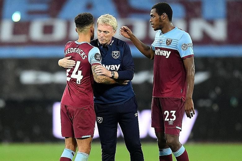 West Ham boss David Moyes with Ryan Fredericks and Issa Diop. Moyes, Diop and Josh Cullen have contracted Covid-19. PHOTO: AGENCE FRANCE-PRESSE