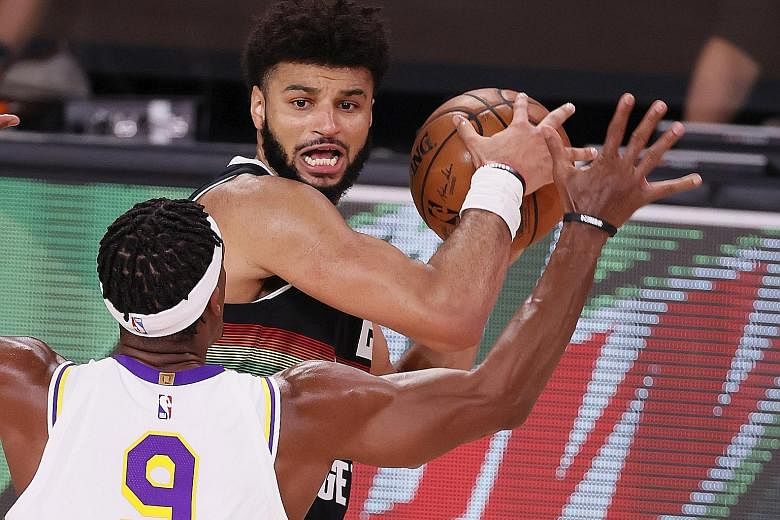 Denver guard Jamal Murray looking to pass around LA Lakers guard Rajon Rondo in Game 3 of the Western Conference Finals in Kissimmee, Florida on Tuesday. He scored 28 points in his side's 114-106 win.