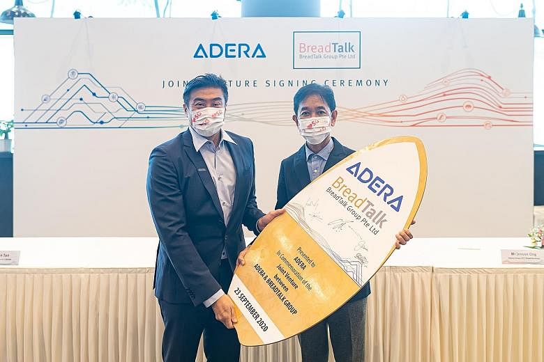 Adera AI chairman Lennon Tan (left) and BreadTalk founder and chairman George Quek at Wednesday's signing event for a joint venture that will develop fintech and digital solutions for small and medium-sized firms.
