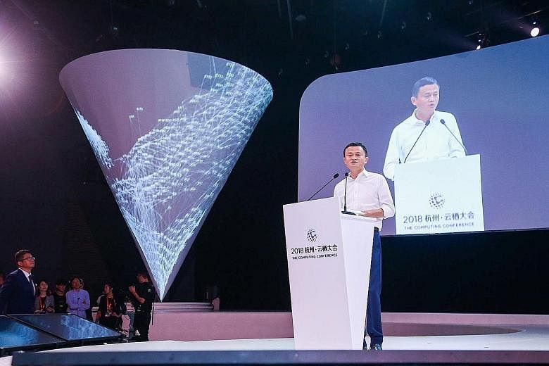 India's Mr Mukesh Ambani, seen here with his wife Nita, is Asia's richest person, followed by Mr Zhong Shanshan. Alibaba co-founder Jack Ma, seen here speaking at the company's tech conference in China's Hangzhou city in 2018, may soon regain his spo