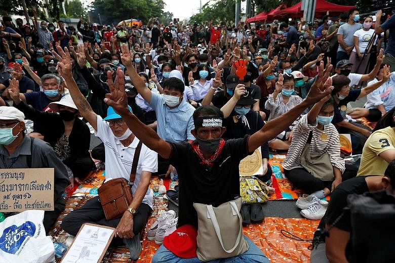 Pro-democracy protesters flashing their three-finger salute as they called for the removal of Prime Minister Prayut Chan-o-cha as well as reforms to the monarchy in front of Parliament in Bangkok yesterday. With the bid to amend Thailand's Constituti