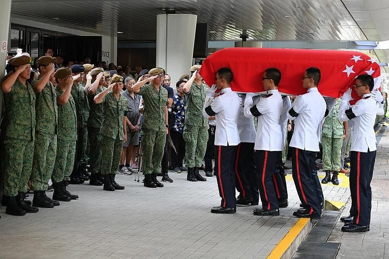 Pallbearers (right) carrying the coffin of full-time national serviceman Dave Lee (above) into the service hall at Mandai Crematorium in May 2018. CFC Lee died about two weeks after being admitted to hospital for heatstroke. ST FILE PHOTOS
