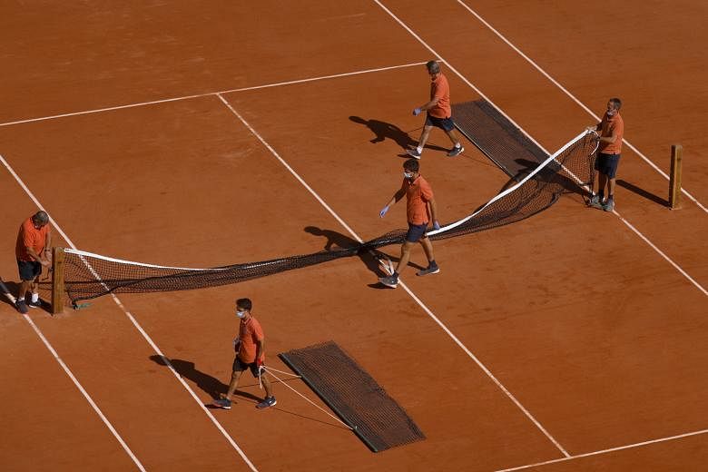 Tournament staff preparing the main Philippe Chatrier court for the French Open Grand Slam which begins on Sunday.