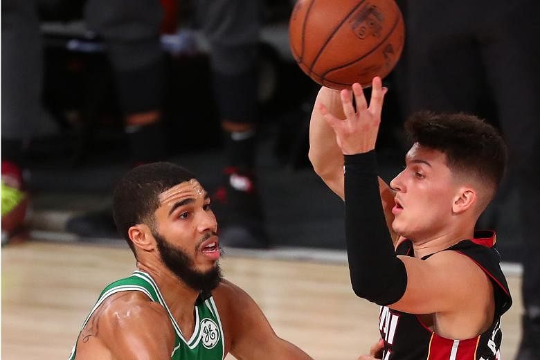 Miami guard Tyler Herro holding off Boston forward Jayson Tatum in Game 4 of the NBA Eastern Conference Finals on Wednesday. His career-best points total helped his team win 112-109 and they are one victory away from a first conference title in six y