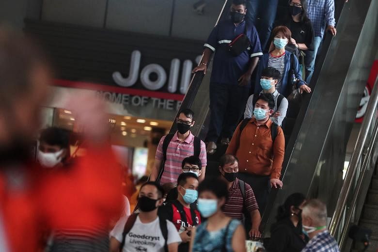 Despite everything we have endured in the fight against Covid-19, the end is still far away, with mask wearing continuing to be the norm and the economy taking a severe hit. And a vaccine is not the endgame. ST PHOTO: KELVIN CHNG