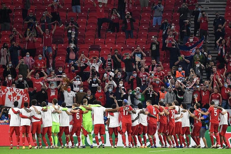 Bayern Munich players celebrating with their supporters after beating Sevilla 2-1 in extra time to win the Uefa Super Cup in Budapest, Hungary, on Thursday.
