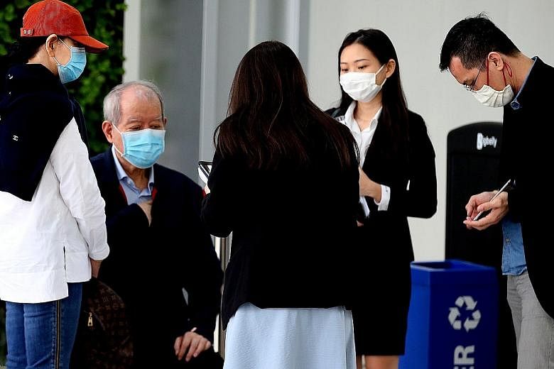 A frail-looking Lim Oon Kuin, better known as O.K. Lim, who came to court yesterday with the help of two women (right), one of whom is a family member, had the new charge of abetment of forgery read to him in Mandarin outside the courtroom (left). Th