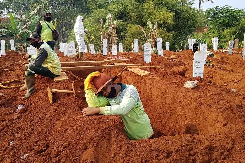 Above: Mr Adang Saputra, a gravedigger at Pondok Ranggon cemetery in East Jakarta, gets up at the crack of dawn to get to work, rotating shifts among other workers to bury the dead till as late as 10pm. Top and right: Family members of Covid-19 victi