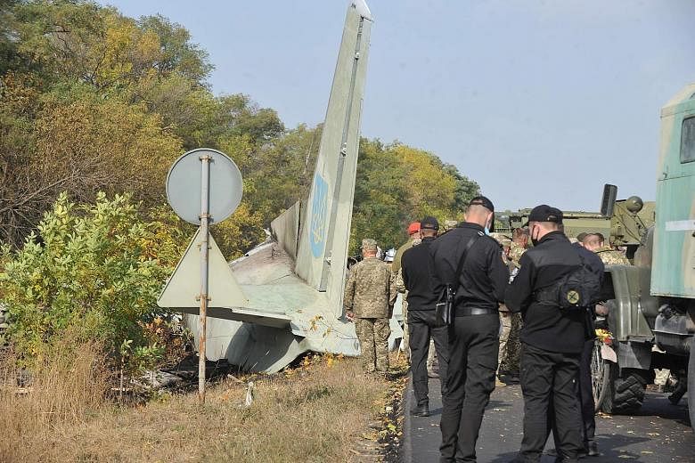 Military personnel at the crash site. The transport plane was carrying 20 cadets and seven crew when it went down.