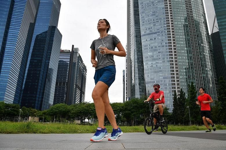 Listening to music while working out can enhance performance, as songs are motivational and provide tempo. Podcasts, while slower, can also aid runners and offer an alternative to music. ST PHOTO: CHONG JUN LIANG