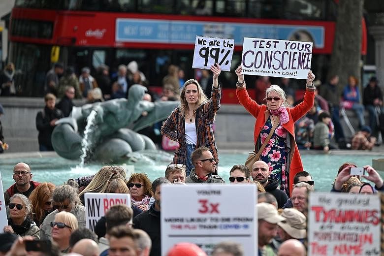 Protesters gathering in London's Trafalgar Square yesterday for a rally against vaccination and government curbs designed to fight Covid-19, including mask-wearing and testing. PHOTO: AGENCE FRANCE-PRESSE