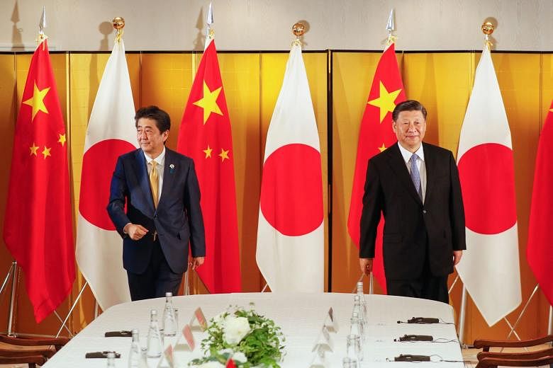 Japan's then Prime Minister Shinzo Abe (left) and Chinese President Xi Jinping at a bilateral meeting ahead of the Group of 20 summit in Osaka last year. In 2007, Mr Abe, with an eye on China, had proposed an "Arc of Democracy" as a loose alliance of