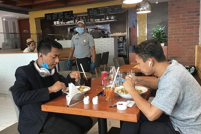 From left: Business partners Rajikant Mangkhom and Lohit Chand Mangkhom eating at CoCo Ichibanya in Gurugram, a Delhi suburb. The restaurant opened in August and averaged around 58 orders a day that month. ST PHOTOS: DEBARSHI DASGUPTA Sushi and More 