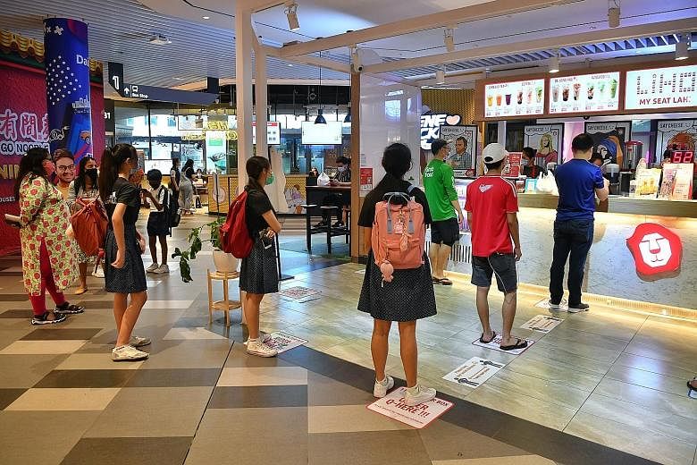 People queueing up to buy bubble tea while observing safe distancing at Our Tampines Hub on June 19, as Singapore moved into phase two of its reopening.