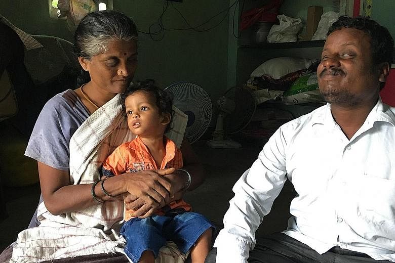Mr Dharman and his wife Uganthai with their two-year-old son Rohit. The couple used to sell items on local trains to earn a living, but lost their income after rail services were halted.