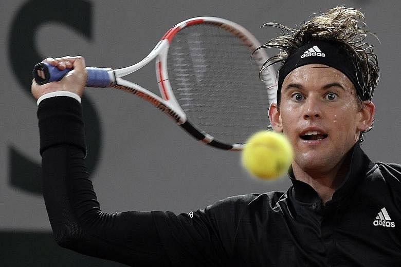 Dominic Thiem hitting a return to Marin Cilic in the first round in Paris. The Austrian shrugged off frosty conditions to win in straight sets. PHOTO: EPA-EFE
