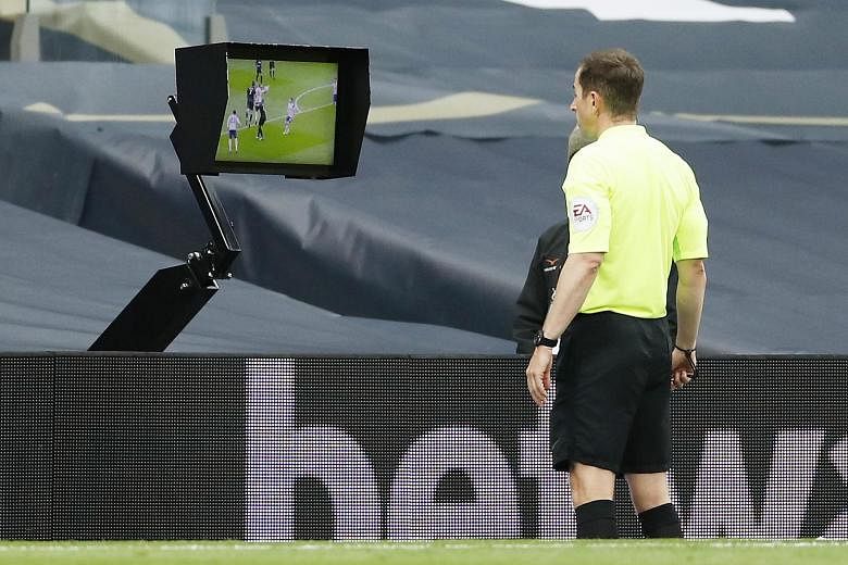 Referee Peter Bankes checking the video assistant referee monitor before awarding a hotly disputed penalty to Newcastle in added time, enabling the visitors to escape with a 1-1 draw at Tottenham on Sunday. The handball incident was the latest in a s