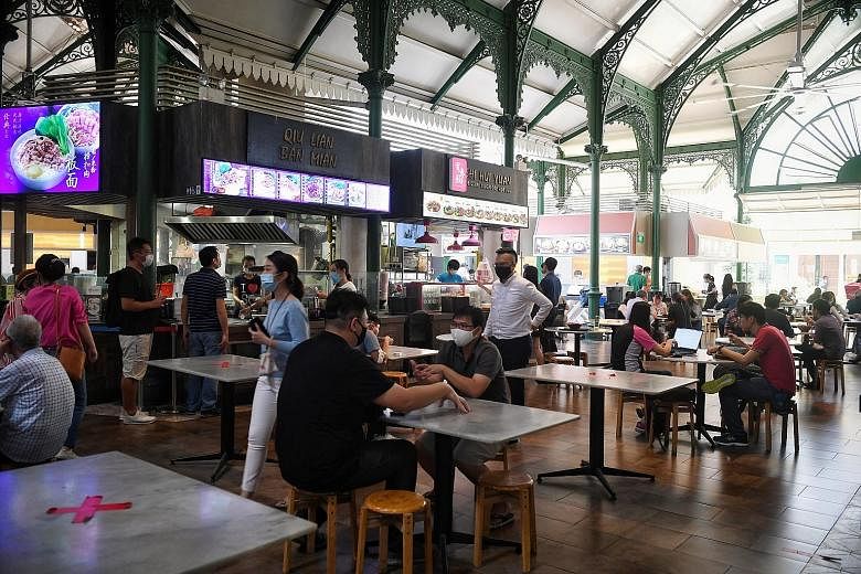 8.22am: The area outside Raffles Place MRT station seemed empty, even as the workday was about to begin. 12.26pm:Diners at Lau Pa Sat (left) during lunchtime yesterday. 12.36pm: It was more crowded at Market Street Interim Hawker Centre (right), with