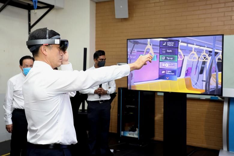 Mr Ong Ye Kung getting a virtual look at the interior of the new North-South and East-West line trains. New features include more open spaces for strollers. Minister for Transport Ong Ye Kung speaking to rail workers at the Bishan train depot yesterd