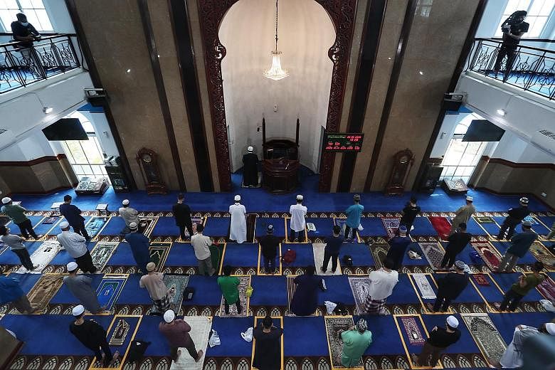 Worshippers at Masjid Al-Istighfar in Pasir Ris on June 26 when mosques resumed Friday prayers. The capacity for Friday prayers in some mosques will be raised to 250, as Muis looks to double the weekly spaces to 30,000.