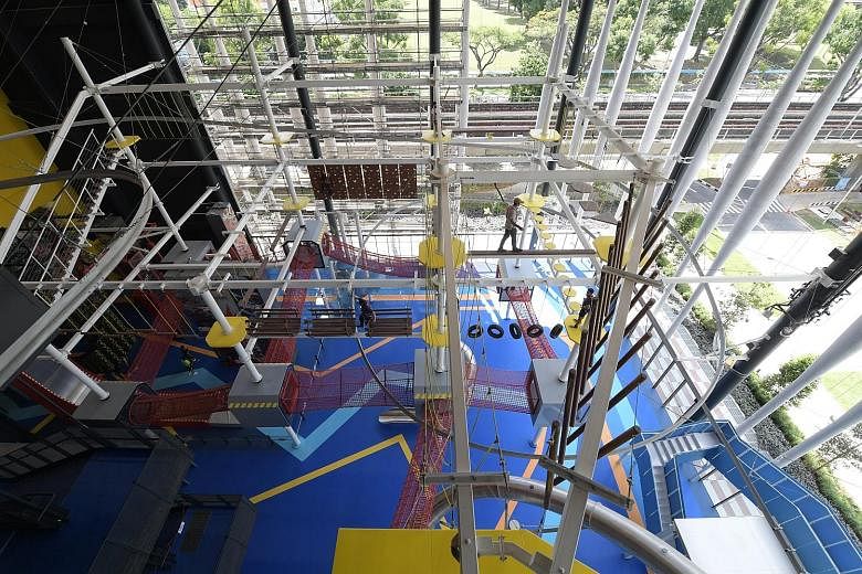 The new Home Team NS Khatib Clubhouse is home to Adventure HQ, a four-storey indoor hub complete with a mid-air obstacle course. The clubhouse also boasts a fully equipped gym. ST PHOTOS: ALPHONSUS CHERN