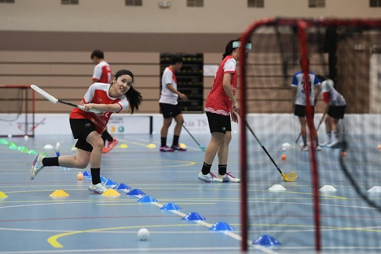 Two-time SEA Games gold medallist Amanda Yeap practising shooting at floorball training. Most sportsmen are still restricted to working out in small groups. ST PHOTO: KHALID BABA