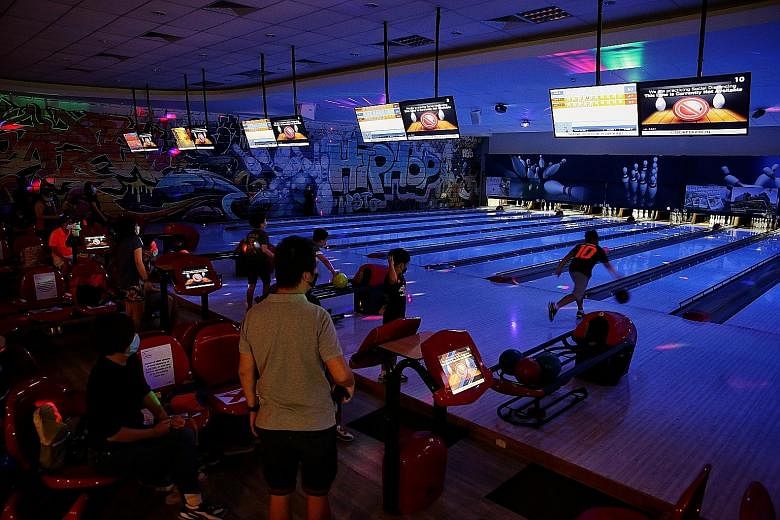 Families bowling at Safra Yishun's Orchid Bowl yesterday. Safra currently has six clubhouses - in Jurong, Mount Faber, Punggol, Tampines, Toa Payoh and Yishun - and one in Choa Chu Kang is expected to be ready in 2022.