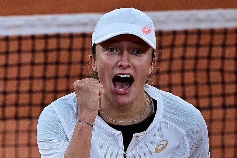 Left: Iga Swiatek celebrating her victory over top seed Simona Halep yesterday. The biggest scalp of her career has ensured that the Pole will be in the French Open quarter-finals, her best run at a Grand Slam. Below: In the men's draw, Italian Janni