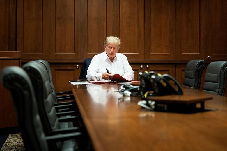 United States President Donald Trump working in a conference room while receiving treatment at Walter Reed National Military Medical Centre in Maryland last Saturday.