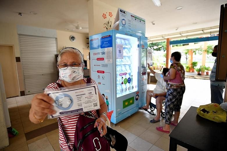 Housewife Ng Yang Cher, 68, with the free mask kit that she collected at Tampines Ville Residents' Committee last month. Some 3.8 million residents collected free mask kits in the latest two-week exercise, which was held from Sept 21 to Sunday. Temas