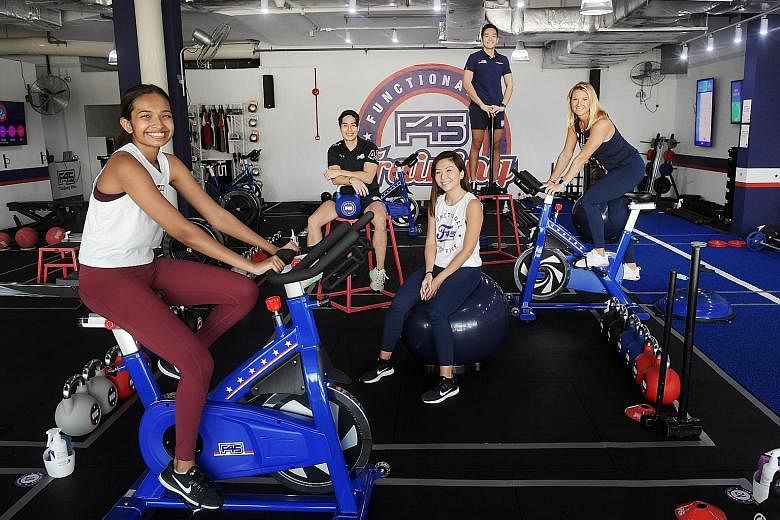 Clockwise, from left: F45 member Anisha Pillai, fitness instructors Nicholas Chong and Ollie Wang, F45 Tanjong Rhu owners Barbora Hogan and Charmaine Wang at their new outlet at Kallang Wave Mall. The owners opened the location in Kallang in late Jun