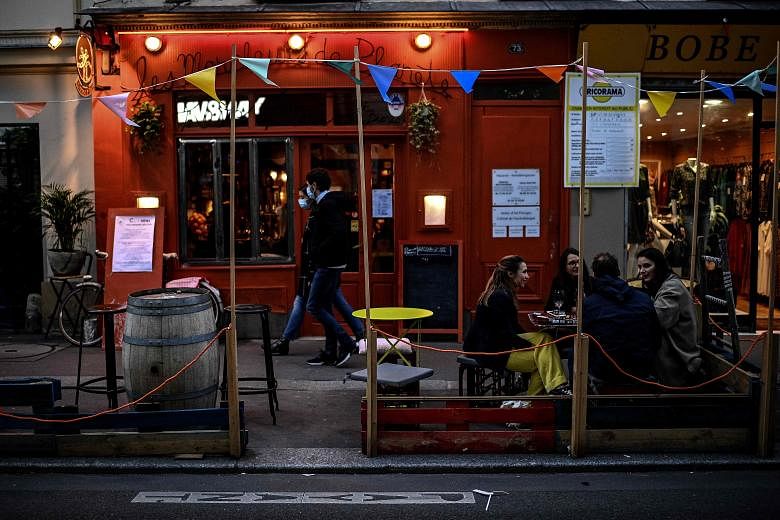 People at a bar in Paris last Saturday. Bars in the French capital have to close for two weeks from today and restaurants must put in place new sanitary protocols to stay open, under the reinforced curbs.