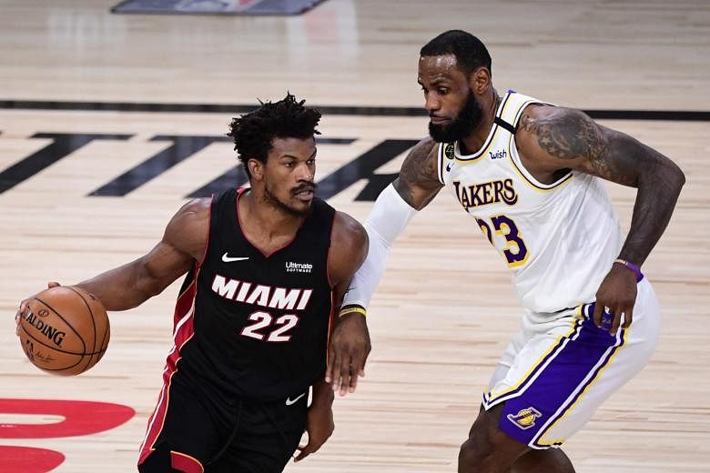Jimmy Butler of the Miami Heat (#22) dribbles against LeBron James of the Los Angeles Lakers during the NBA Finals in Florida on Oct 04, 2020.