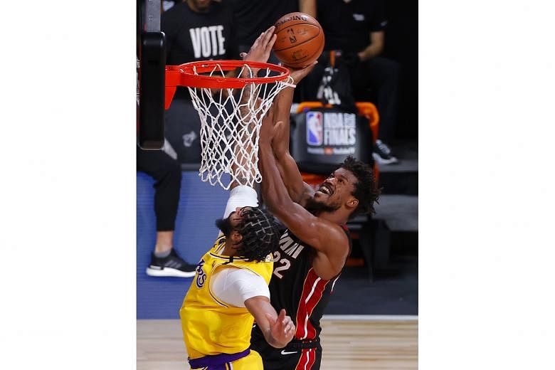 Anthony Davis proving his worth defensively for the LA Lakers as he restricted Miami danger man Jimmy Butler (right) to just 22 points during Game 4 of the NBA Finals on Tuesday. The Lakers won 102-96. 