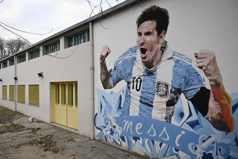 Lionel Messi, depicted in a mural in Buenos Aires, will lead Argentina out for the World Cup qualifier against Ecuador today. 