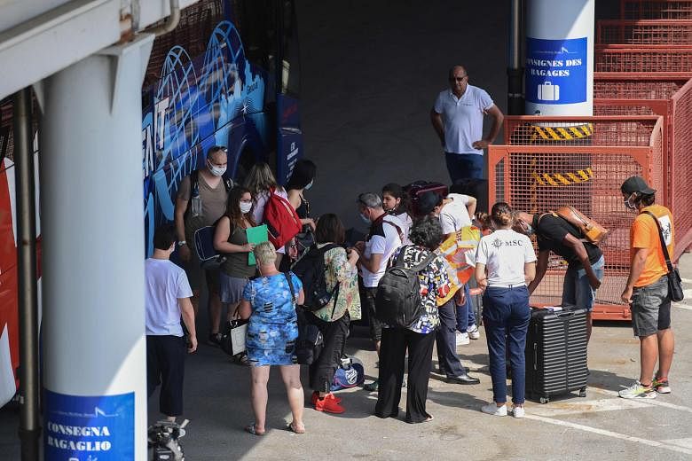 Passengers in masks getting ready to pass through the different health security controls before boarding the MSC Grandiosa cruise ship in Genoa, Italy, in August.