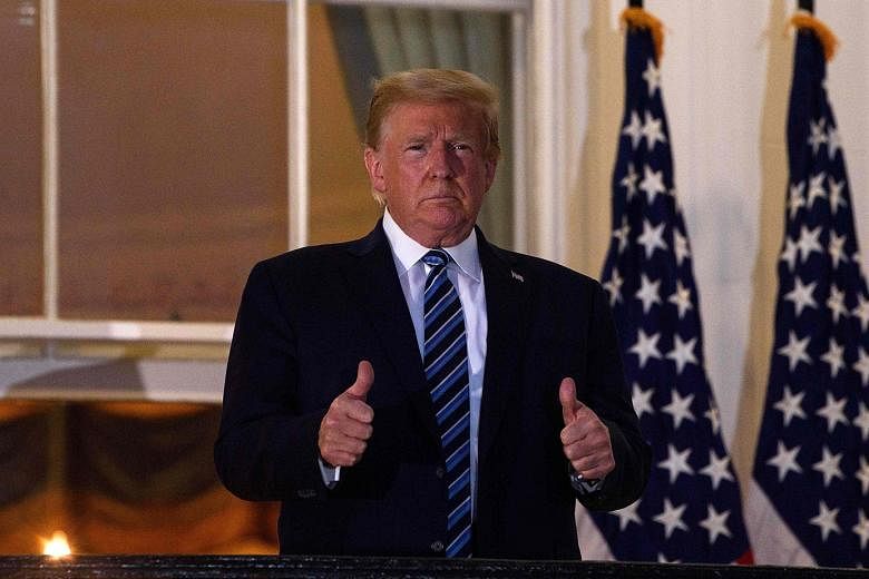 US President Donald Trump giving the thumbs up from the Truman Balcony upon his return to the White House on Monday from Walter Reed Medical Centre, where he underwent treatment for Covid-19.