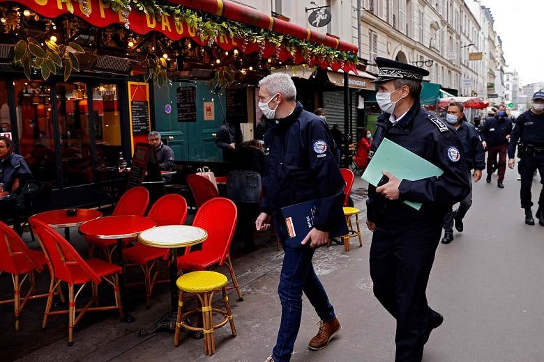 Police officers patrolling a street lined with restaurants in Paris on Tuesday. 