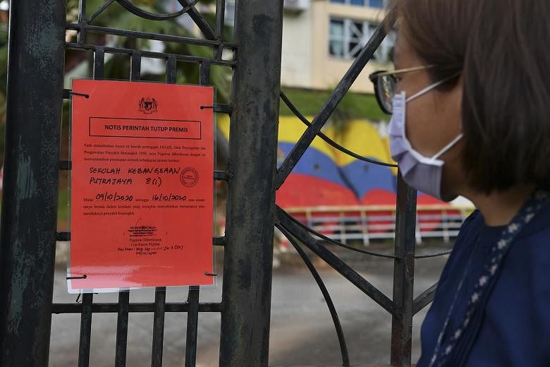 A sign outside a school in Putrajaya indicating that it will remain closed until Oct 16. An informal poll in a Facebook group of Malaysian parents of primary school pupils showed that the majority wanted schools to be closed. 