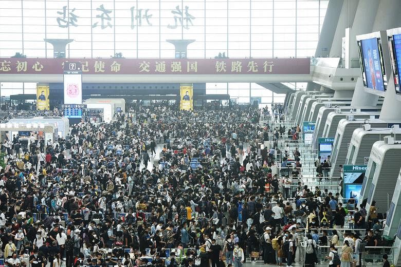 Travellers at the Hangzhou Railway Station in China's eastern Zhejiang province, on the final day of the national Golden Week holiday on Thursday. This year's travel rush has been closely watched as a barometer of the economic recovery of China, whic