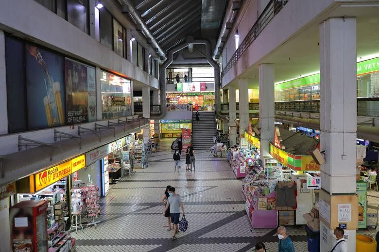 The retail atrium in Golden Mile Complex. The property was completed in 1973 and has about 48 years left on its lease. It was one of the first developments here to feature offices, shops and residences.