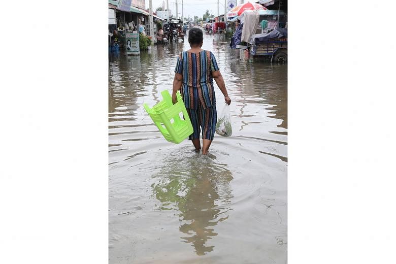 A flooded street on the outskirts of Phnom Penh, Cambodia, yesterday. Floods have displaced thousands of people in western Cambodia. 