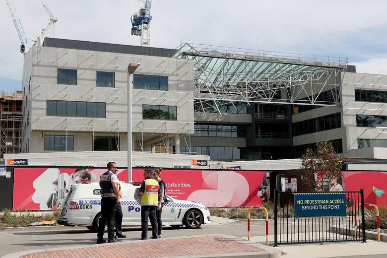 Emergency services at the scene of the collapsed building in Curtin University in Perth, Australia, yesterday. One person died and two men were hospitalised with multiple injuries.  