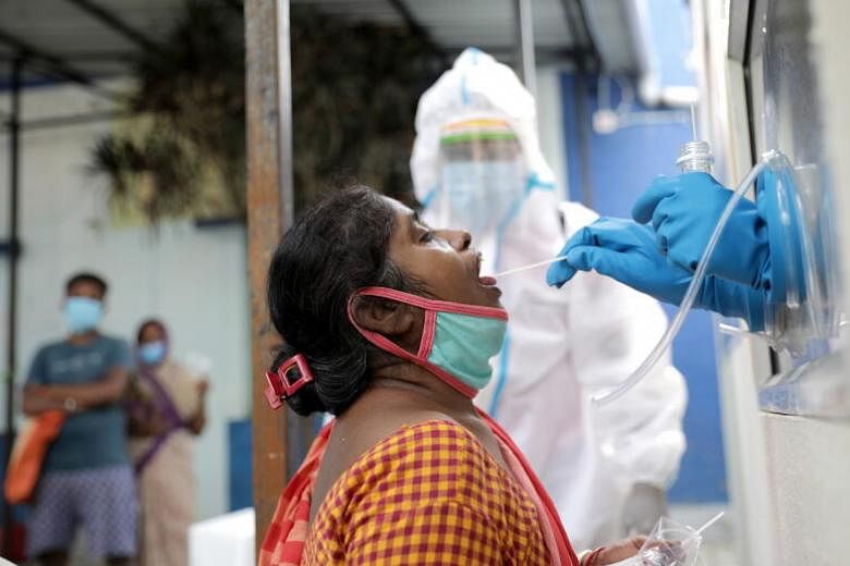 Health officials taking a swab sample from a woman in Kolkata, on Oct 13, 2020.