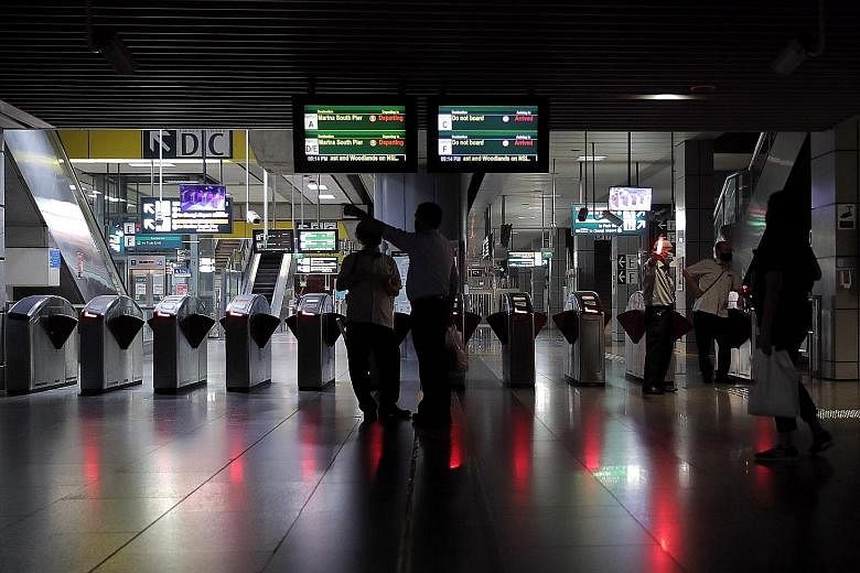 The 31/2-hour breakdown along parts of the North-South, East-West and Circle MRT lines caused by a faulty power cable led to blackouts at stations such as Jurong East (above), where commuters stranded in trains were guided by SMRT staff to walk along