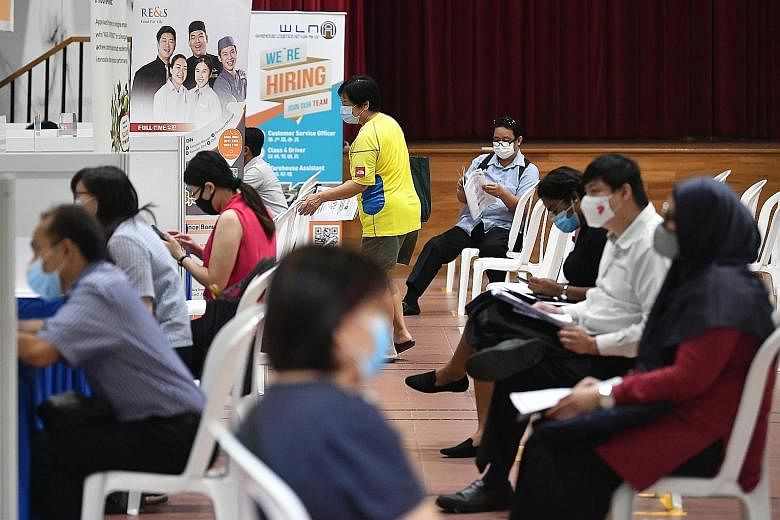 Job seekers at an employment fair held at Bukit Panjang Community Centre in August. The career centres in the HDB heartland under the SGUnited Jobs and Skills Package are aimed at helping both white-and blue-collar workers, said Manpower Minister Jos