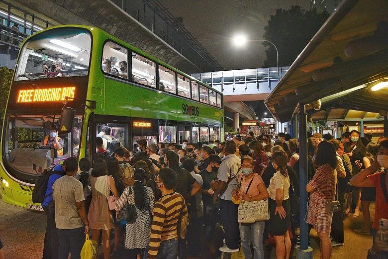 The scene outside Queenstown MRT station yesterday evening as train commuters waited to board free bus services. There were no train services on parts of the North-South and East-West lines at about 7pm, and later on the Circle Line at 7.30pm, in wha