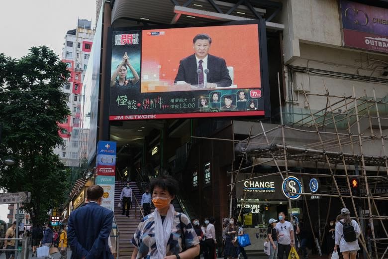 A giant TV screen in Hong Kong showing Chinese President Xi Jinping making a speech in Shenzhen yesterday to mark 40 years since the city pioneered a special economic zone that helped propel its exponential growth.