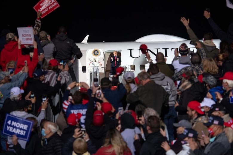 Democratic presidential candidate Joe Biden at a drive-in rally in Miramar, Florida, on Tuesday. He said Mr Donald Trump had recklessly dismissed the threat that Covid-19 had posed to the state's at-risk population. President Donald Trump disembarkin