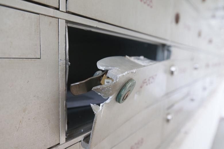 Police said yesterday that they have received reports of letterboxes in Marsiling (left) and Bukit Merah being tampered with. PHOTO: LIANHE ZAOBAO